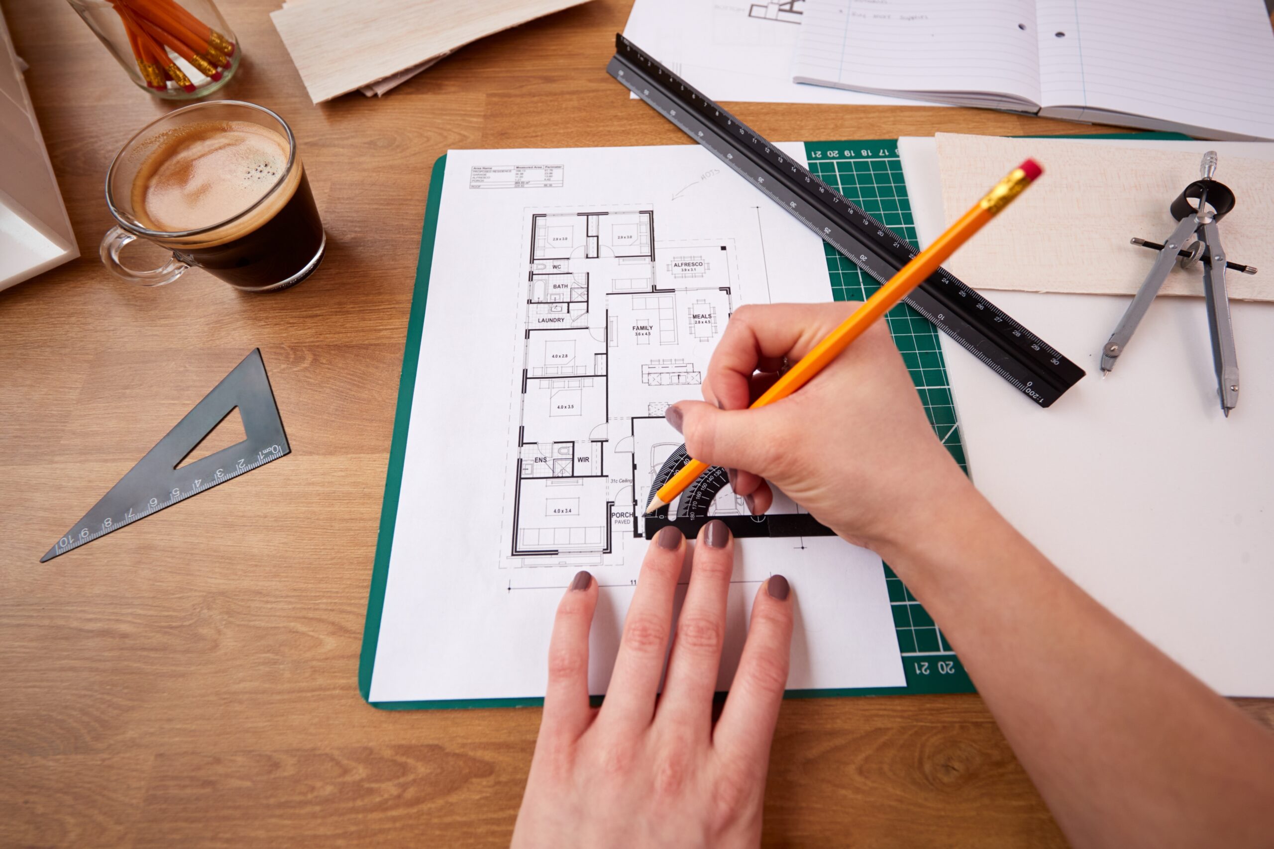 Pov,Shot,Of,Female,Architect,Working,In,Office,Measuring,Plans